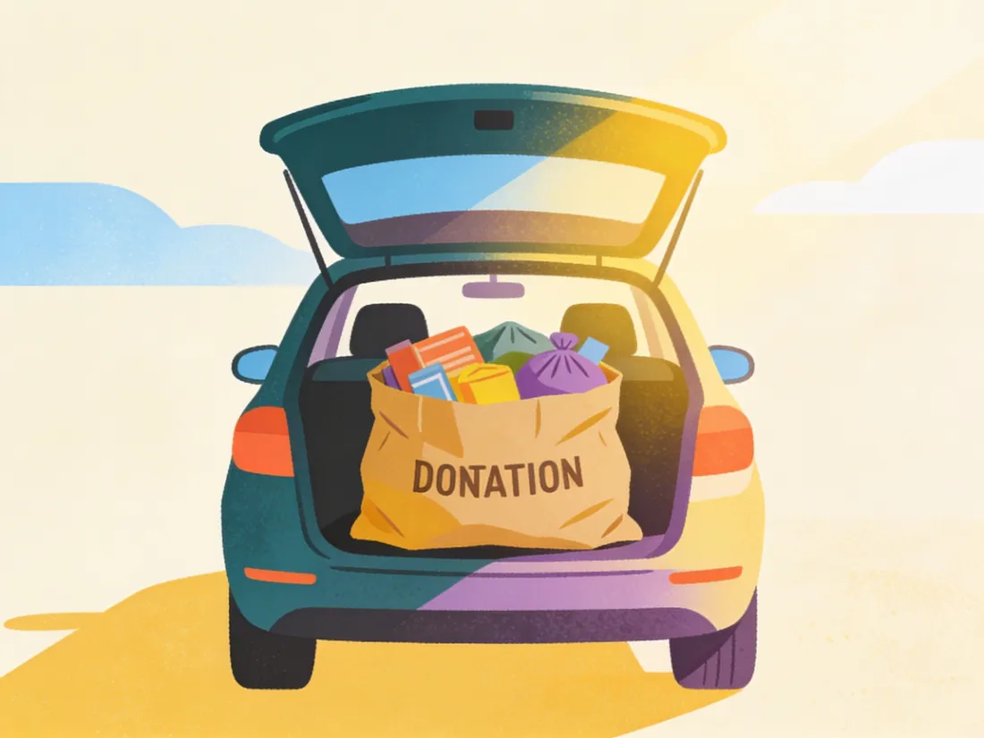A donation bag sitting in an open car trunk.