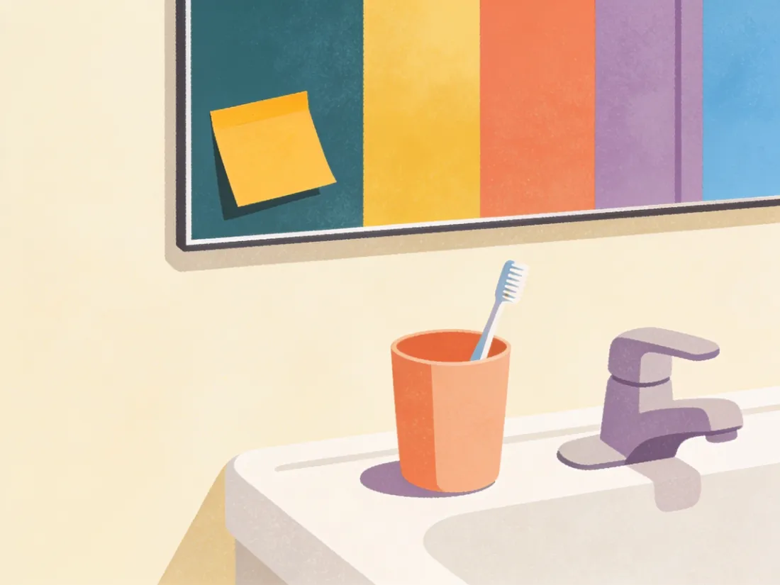 A bathroom mirror with one bright sticky note in the corner.